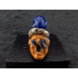 Phoenician sand-core glass comic face trading amulet