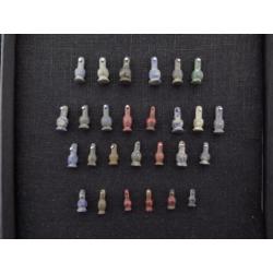 Collection of 27 Egyptian crystal poppy bead amulets